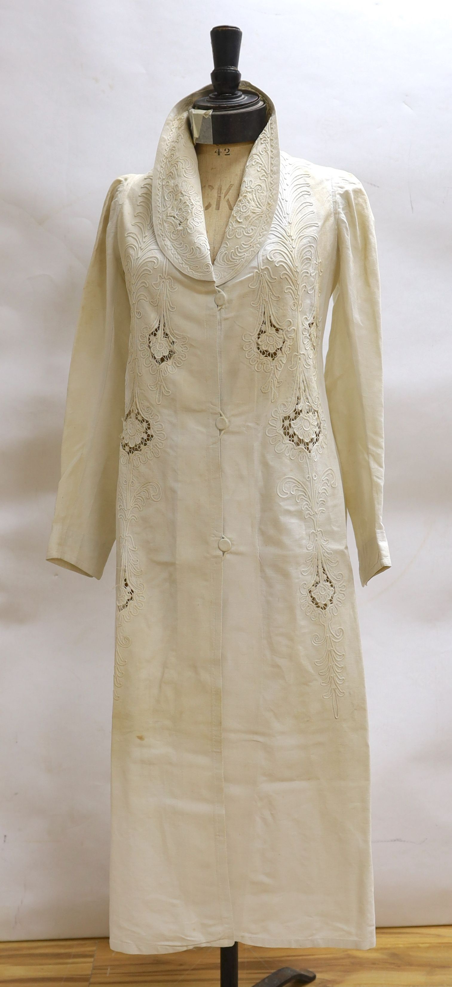 An Edwardian white/cream linen lady's coat with cut work detail and unusual button detail to the back